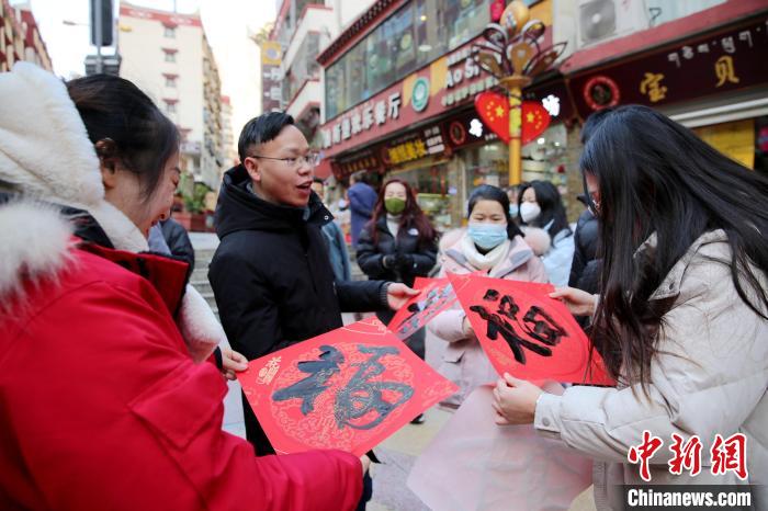 街頭市民收到送的“福”字?！±钣腊?攝