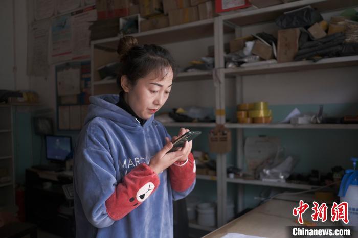 正在快遞站點內(nèi)忙碌的楊莉春。　何蓬磊 攝